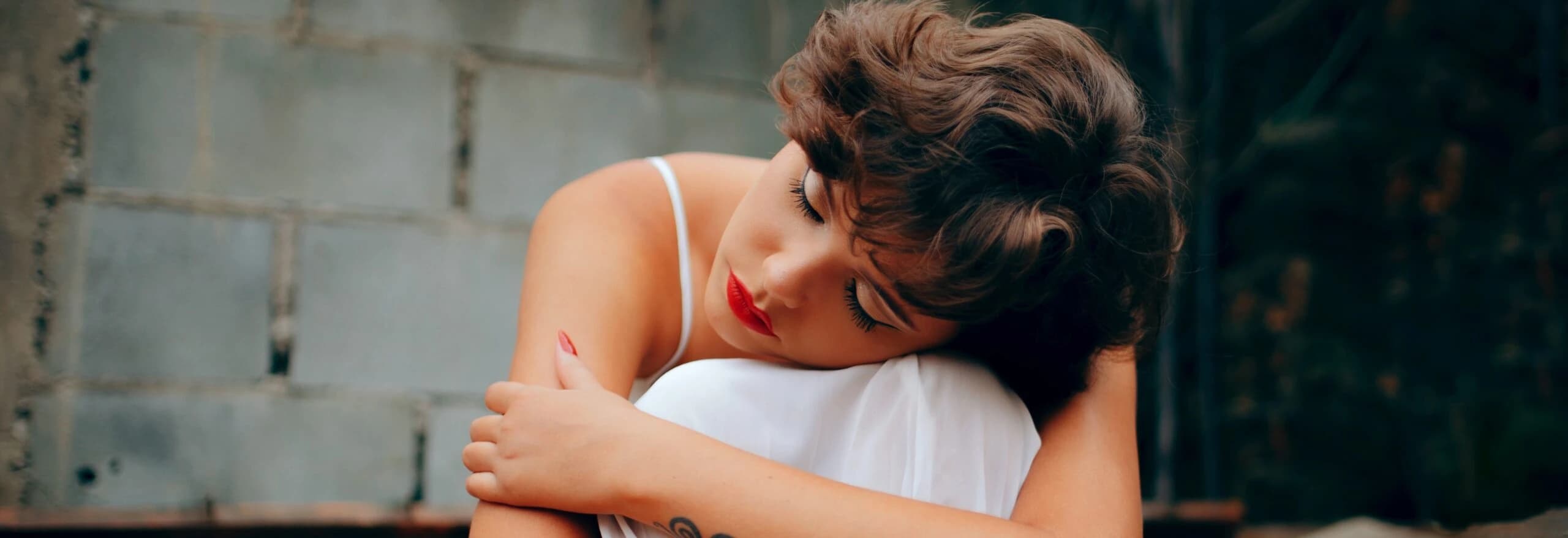 woman hugs knees representing adjustment disorder with anxiety.