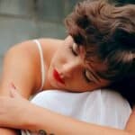 woman hugs knees representing adjustment disorder with anxiety.