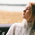 woman looking out window representing chronic adjustment disorder